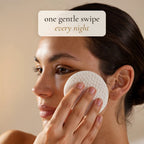 One gentle swipe every night: woman sweeping a Luminelle pad across her cheek